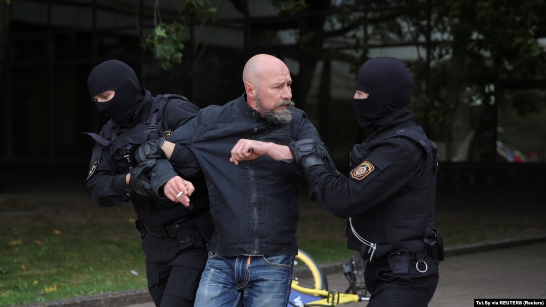 Maskirani pripadnici policije privode demonstranta (Foto: Tut.By via REUTERS)