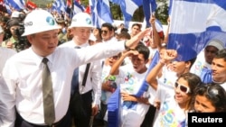 HK Nicaragua Canal Development Investment Co Ltd (HKND Group) Chairman Wang Jing greets youths during the start of work on the Interoceanic Grand Canal in Brito town, Dec. 22, 2014, in this handout provided by the Presidential Palace Nicaragua.