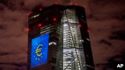 FILE - A light installation is projected onto the European Central Bank building in Frankfurt, Germany, on Dec. 30, 2021. The International Monetary Fund forecast on Oct. 22, 2024, that the EU economy will lag the U.S.'s again next year.