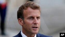 French President Emmanuel Macron talks to reporters before his talks with Madagascar's President Andry Rajoelina on Aug. 27, 2021, at the Elysee Palace in Paris.