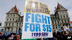 Supporters of a $15 minimum wage rally at the New York State Capitol in Albany on March 15, 2016. Supporters said an increase will boost salaries for women, who tend to earn less than men. (AP Photo/Mike Groll)
