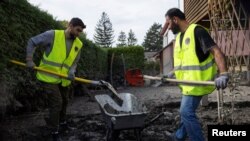 Migrants from the Free Syrian Community of Austria association volunteered to clean up after floods in Kritzendorf, Austria, Sept. 26, 2024.