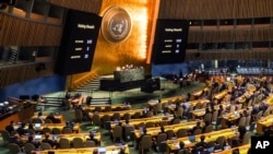 Video monitors showing the outcome of a United Nations General Assembly vote over Russia's referendum in Ukraine, October 12, 2022.
