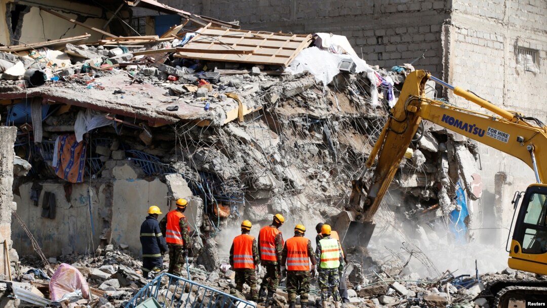 Emergency personnel work at the scene after a building collapsed in a residential area of Nairobi, Kenya, June 13, 2017.