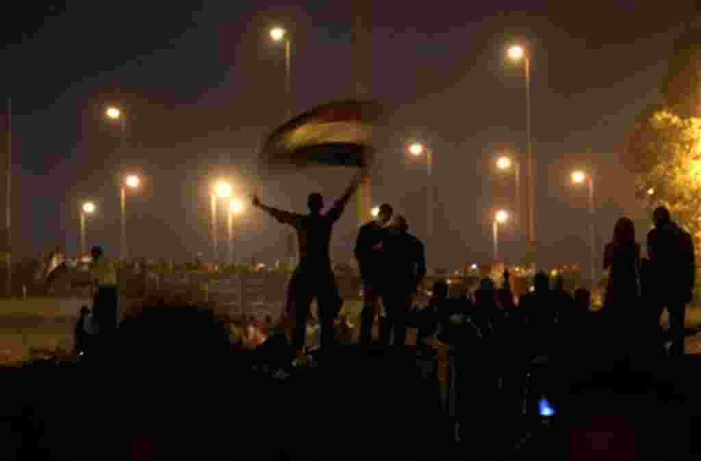 Anti-government protesters celebrate in the street in downtown Cairo, Egypt , Egypt Friday, Feb. 11, 2011. Fireworks burst over Tahrir Square and Egypt exploded with joy and tears of relief after pro-democracy protesters brought down President Hosni Mubar