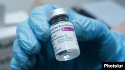 A medical worker holds a vial of the Oxford/AstraZeneca coronavirus vaccine at a polyclinic in Yerevan, Armenia, April 28, 2021.