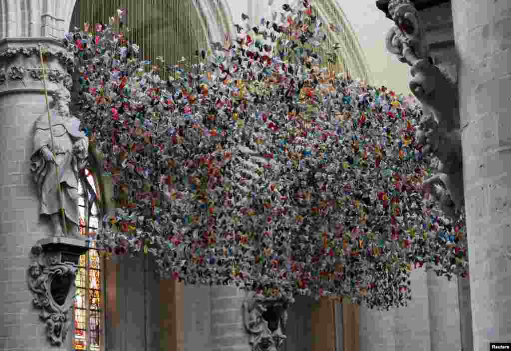 An art installation made of 20,325 origamis called &quot;Origami For Life&quot; by Belgian designer and artist Charles Kaisin is pictured at the Cathedral of St. Michael and St. Gudula, in Brussels. 