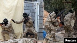 Libyan security forces trained by the Turkish military demonstrate their skills during a graduation ceremony in Khums, Libya April 8, 2021. (Hazem Ahmed/Reuters)