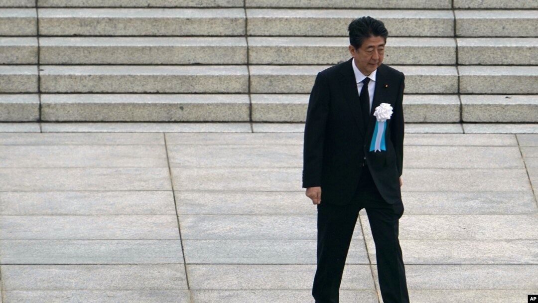 FILE - In this Aug. 6, 2020 photo, Japanese Prime Minister Shinzo Abe walks off after delivering a speech during a ceremony to mark the 75th anniversary of the bombing at the Hiroshima Peace Memorial Park, in Hiroshima, western Japan. 