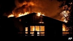A home burns in a wildfire in Santa Clarita, California, on October 24, 2019.