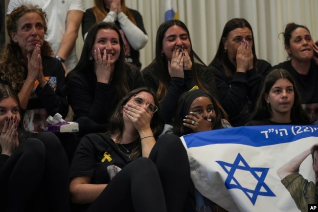 Friends of Sagui Dekel Chen react as they watch a live broadcast of his release from Hamas captivity in Giv'ot Bar, southern Israel, Feb. 15, 2025.