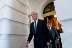 FILE - Robert Mueller, then-special counsel probing Russian interference in the 2016 election, departs Capitol Hill following a meeting with lawmakers, in Washington, June 21, 2017.