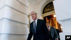 FILE - Robert Mueller, then-special counsel probing Russian interference in the 2016 election, departs Capitol Hill following a meeting with lawmakers, in Washington, June 21, 2017.