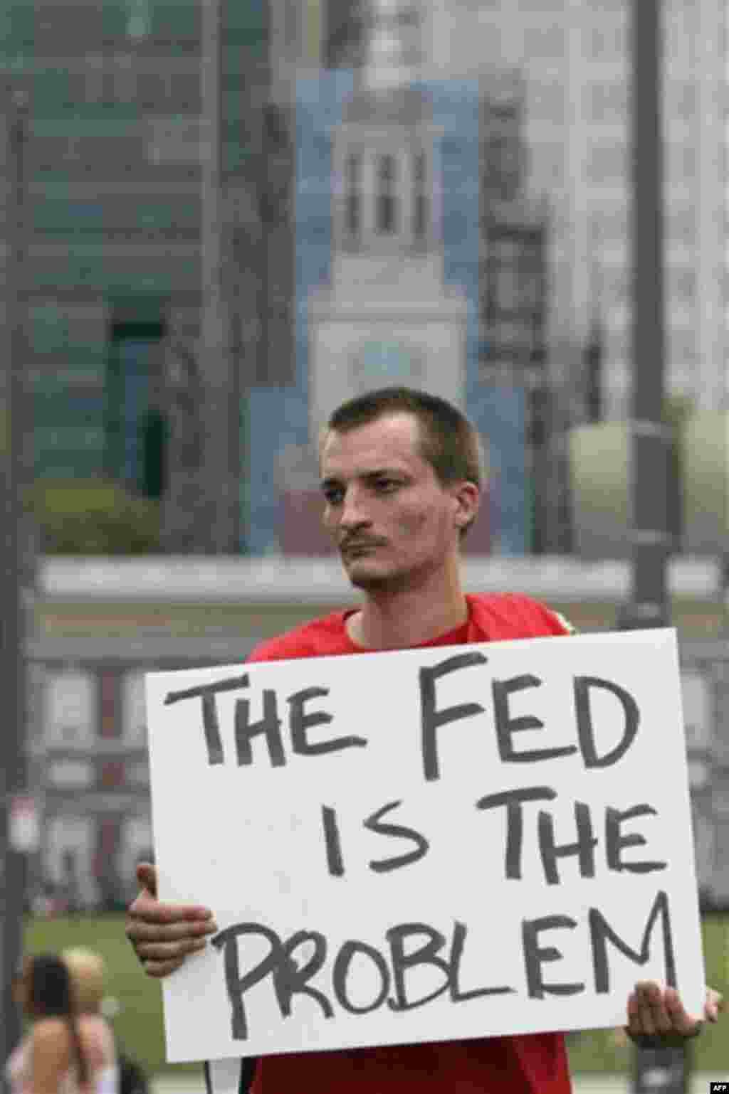 Ben Brubaker holds a sign while he participates in the '"Energy Independence Day Tea Party" rally on Independence Mall in Philadelphia, on Monday July 4, 2011. (AP Photo/Joseph Kaczmarek)