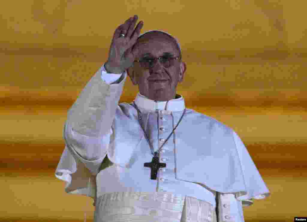 Newly elected Pope Francis, Cardinal Jorge Mario Bergoglio of Argentina appears on the balcony of St. Peter's Basilica after being elected by the conclave of cardinals, at the Vatican, March 13, 2013. White smoke rose from the Sistine Chapel chimney and t