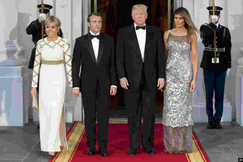 President Donald Trump, first lady Melania Trump, French President Emmanuel Macron and his wife Brigitte Macron, pose for photographs as they arrive for a State Dinner at the White House in Washington, April 24, 2018. 