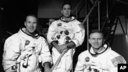 FILE - Apollo 8 astronauts, from left, James Lovell, command module pilot; William Anders, lunar module pilot; and Frank Borman, commander, stand in front of mission simulator at the Kennedy Space Center in Florida, Dec. 18, 1968.