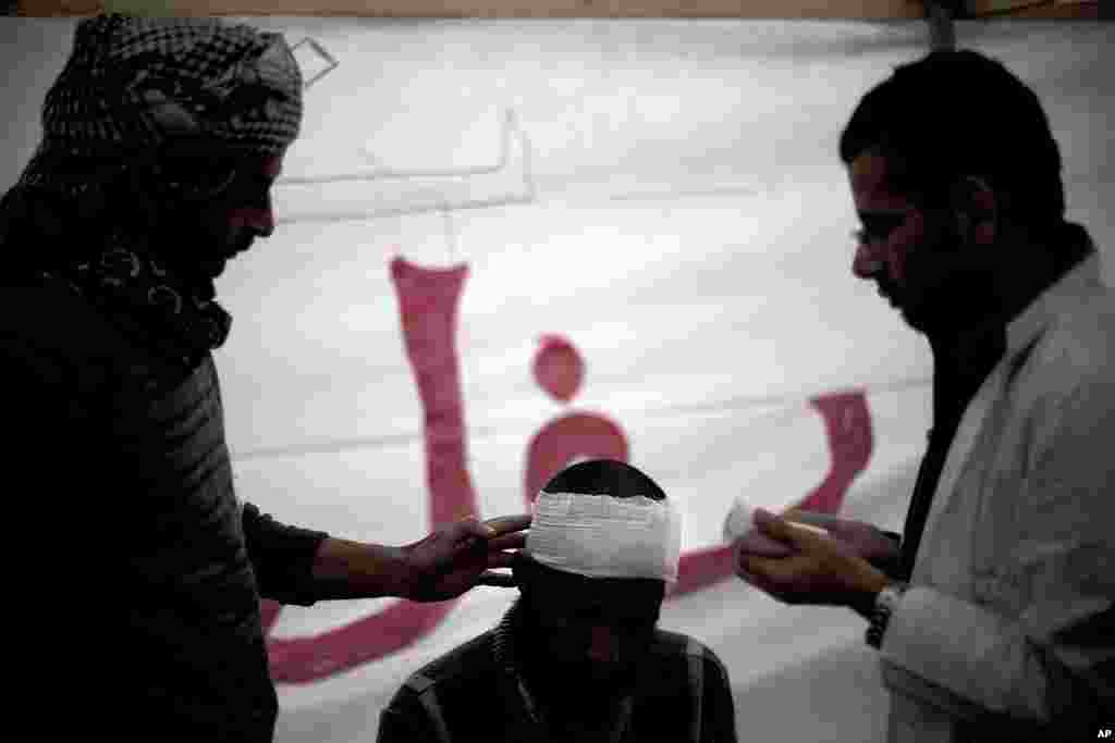 An injured protester is treated by a doctor in Tahrir Square in Cairo, Egypt, November 24, 2011. (AP)