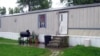 This photo taken July 17, 2015, shows a mobile home that prosecutors say Guatemalan teenagers were forced to live in when they weren’t working at egg farms in Marion, Ohio. 