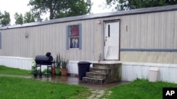 This photo taken July 17, 2015, shows a mobile home that prosecutors say Guatemalan teenagers were forced to live in when they weren’t working at egg farms in Marion, Ohio. 