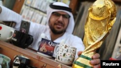 FILE -A mock-up of the World Cup is seen at a shop in Souk Waqif in Doha, Qatar, July 13, 2018. 