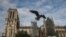 FILE - A seagull flies near Notre Dame Cathedral, Nov. 25, 2020, in Paris.