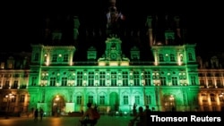 Green lights are projected onto the facade of the Hotel de Ville in Paris, France, after U.S. President Donald Trump announced his decision that the United States will withdraw from the Paris Climate Agreement, Nov. 4, 2020.