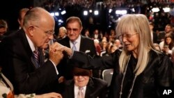 Former mayor of New York City Rudy Giuliani, kisses Miriam Adelson's hand at Hofstra University in Hempstead, N.Y. Miriam Adelson is a philanthropist and humanitarian, but is perhaps best known as the wife of Sheldon Adelson who is considered a powerful Republican donor.
