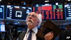 Trader Peter Tuchman works on the floor of the New York Stock Exchange Monday, March 16, 2020. (AP Photo/Craig Ruttle)