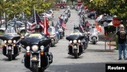 FILE - Patriot Guard Riders escort a motorcade carrying 200 POWs for the 40th anniversary of the homecoming of Vietnam POWs at Richard Nixon Presidential Library and Museum in Yorba Linda, California, May 23, 2013.