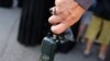 A man holds a walkie-talkie device after he removed the battery, in Beirut's southern suburbs on Sept. 18, 2024. 