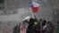 Demonstrators wave a Chile flag during a protest against Chile's government in Santiago, Chile, Nov. 11, 2019. 