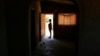 FILE: A 13-year-old teenage mother, stands at the entrance of her home in Murehwa, 80 kilometres (50 miles) northeast of Zimbabwe's capital Harare, Friday, Dec. 10, 2021. (AP Photo/Tsvangirayi Mukwazhi)