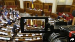 The rostrum of Ukraine's parliament is seen through a reporter's camera monitor in Kyiv, Sept. 17, 2015.