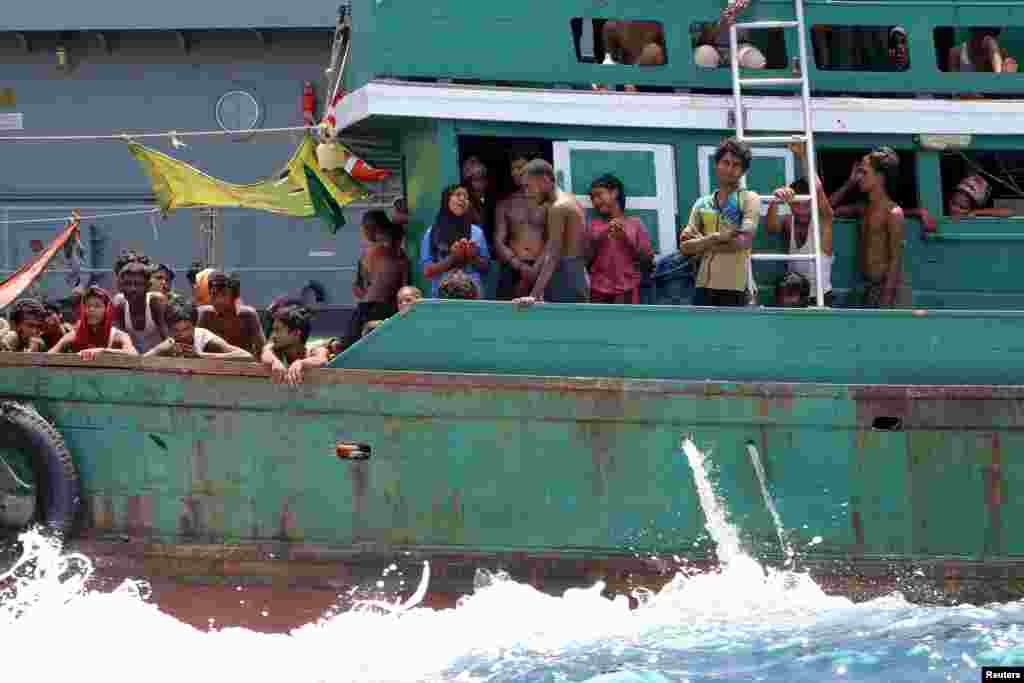 Beberapa migran putus asa setelah angkatan laut Thailand menghalau kapal mereka dari negara itu, di perairan dekat pulau Koh Lipe (16/5). ​(Reuters/Aubrey Belford)