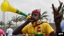 FILE - A Mali supporter gestures and blows a vuvuzela horn upon the arrival of Mali's team at Malabo airport, Jan. 16, 2015, ahead of the 2015 Africa Cup of Nations football tournament.