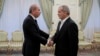 A handout picture released by the Iranian presidential office shows Iranian President Masoud Pezeshkian, right, welcoming Jordan's foreign minister Ayman Safadi ahead of their meeting in Tehran on Aug. 4, 2024. (Photo by Iranian Presidency / AFP)