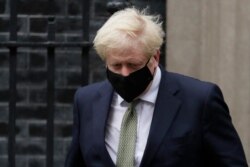 FILE - Britain's Prime Minister Boris Johnson leaves Downing Street to attend parliament in London, Oct. 12, 2020.