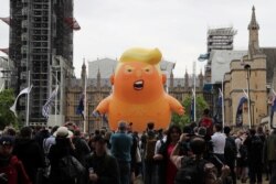 A "Baby Trump" balloon is seen over demonstrators as they participate in an anti-Trump protest in London, Britain, June 4, 2019.