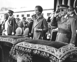 FILE - Former Spanish dictator General Francisco Franco salutes beside his wife Carmen Polo the then Prince Juan Carlos of Spain and his wife Princess Sofia during a ceremony at El Pardo Palace, near Madrid, Spain, Oct. 4, 1975.
