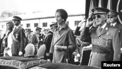 FILE - Former Spanish dictator General Francisco Franco salutes beside his wife Carmen Polo, the then Prince Juan Carlos of Spain and his wife Princess Sofia as they listen to the national anthem during a ceremony at El Pardo Palace, Oct. 4, 1975.