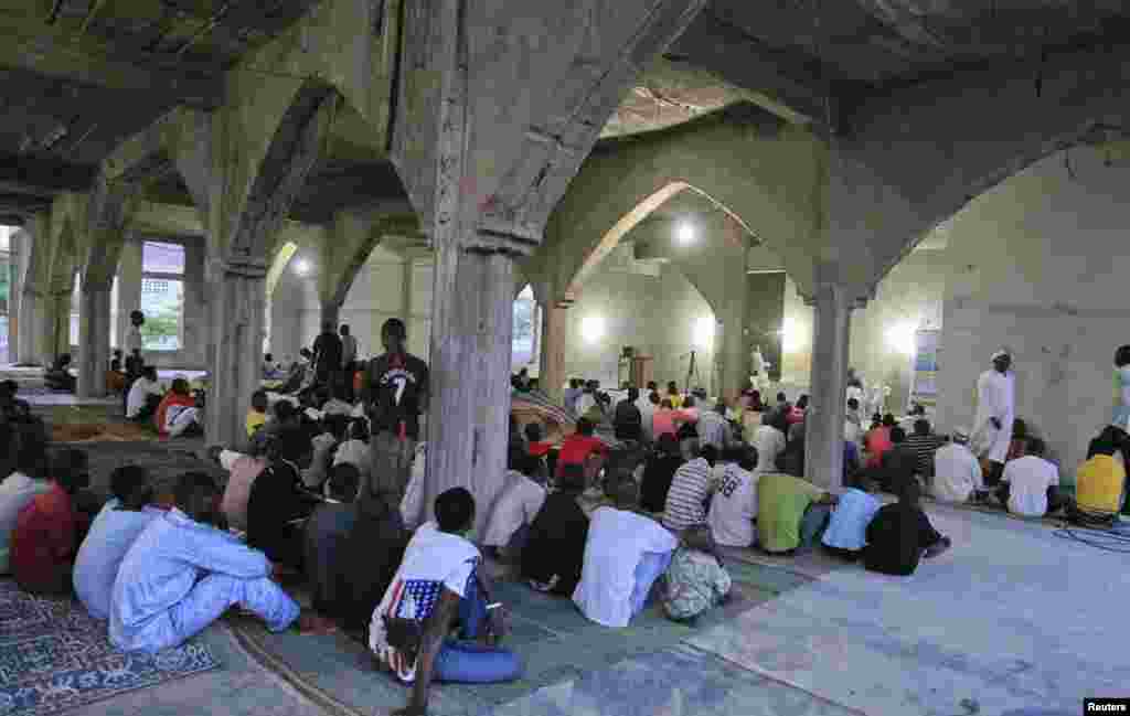 People listen to teachings before breaking fast during the Islamic holy month of Ramadan at Nasfat Mosque in Utako, Abuja.