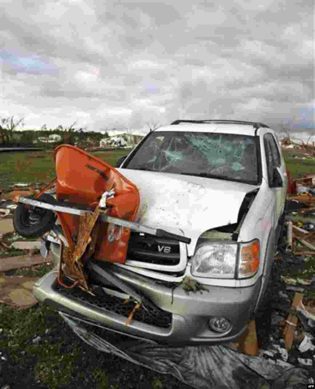 A vehicle sits damaged after a tornado hit Pleasant Grove just west of downtown Birmingham a day earlier, on Thursday, April 28, 2011, in Birmingham, Ala. (AP Photo/Butch Dill)