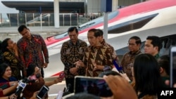 FILE - Indonesian President Joko Widodo answers journalists questions during the inauguration of the Jakarta-Bandung high-speed train named 'Whoosh' at Padalarang station in Padalarang, West Java on Oct. 2, 2023.