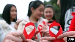 Volunteers take part in an event to mark World Aids Day in Chongqing, China, Nov. 30, 2015. 