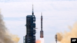 A Long March-2F Y12 rocket carrying a crew of Chinese astronauts in a Shenzhou-12 spaceship lifts off at the Jiuquan Satellite Launch Center in Jiuquan in northwestern China, June 17, 2021.