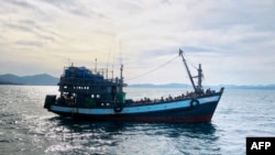 FILE - This handout photo released April 5, 2020, by the Malaysian Maritime Enforcement Agency shows a boat carrying suspected Rohingya refugees in Malaysian territorial waters. Similar boats are currently stranded in waters off Bangladesh.