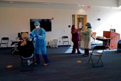 FILE - A student, at left, receives a coronavirus rapid test in the student health center on campus at North Carolina Agricultural and Technical State University in Greensboro, North Carolina, Feb. 3, 2021.