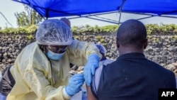 A man receives a vaccine against Ebola from a nurse outside the Afia Himbi Health Center on July 15, 2019 in Goma.