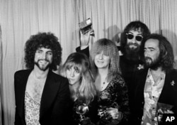 FILE - Members of the rock group Fleetwood Mac, from left, Lindsey Buckingham, Stevie Nicks, Christine McVie, Mick Fleetwood, and John McVie pose with their Album of the Year Grammy Award for "Rumours" in Los Angeles, Feb. 23, 1978. (AP Photo/Richard Drew, File)